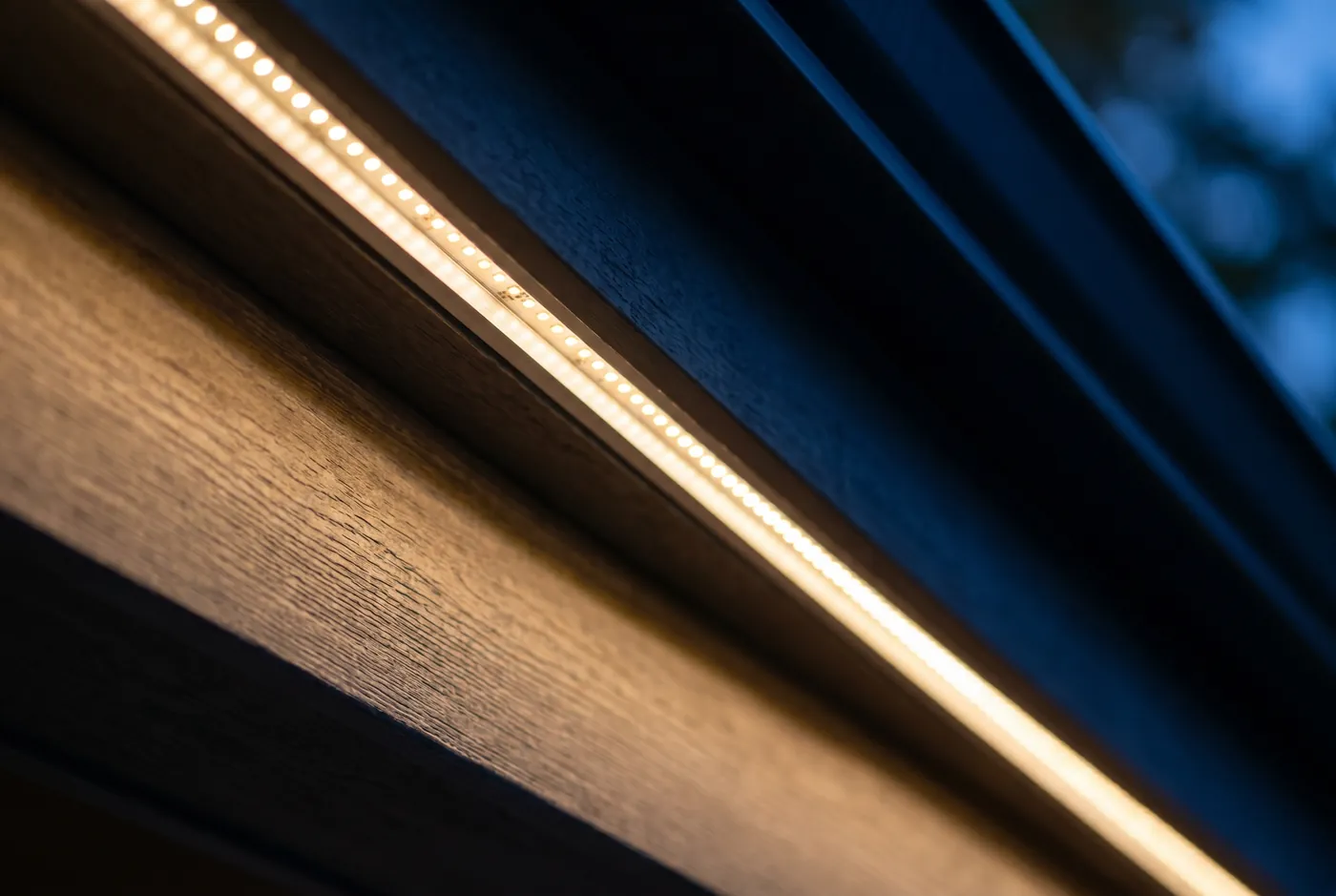 Close-up of the aluminum channel and LED points fitted under a roofline
